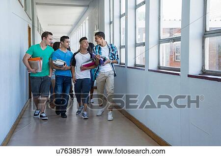 Students walking down hallway, chatting View Large Photo Image Stock Image - Students walking down hallway, chatting. Fotosearch