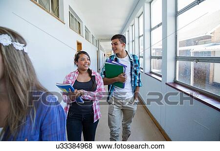 Students walking down hallway, chatting View Large Photo Image Stock Photo - Students walking down hallway, chatting. Fotosearch
