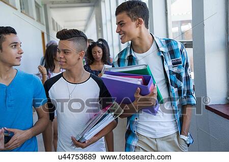 Students walking down hallway, chatting View Large Photo Image Stock Photo - Students walking down hallway, chatting. Fotosearch