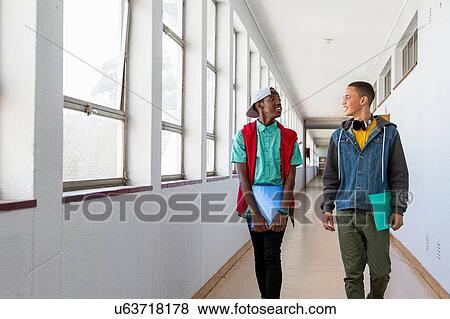 Students walking down hallway, chatting View Large Photo Image Stock Photo - Students walking down hallway, chatting. Fotosearch