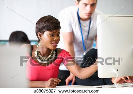 Students working on desktop computer in classroom View Large Photo Image Stock Photo - Students working on desktop computer in classroom. Fotosearch