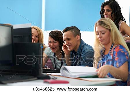 Stock Photography - Students working together in computer class. Fotosearch