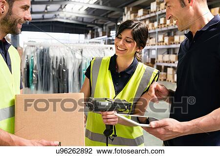 Supervisor instructing workers using digital tablet in distribution warehouse View Large Photo Image Stock Image - Supervisor instructing workers using digital tablet in distribution warehouse. Fotosearch