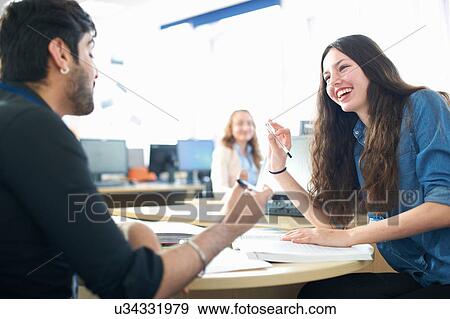 Teacher and female student having classroom tutorial View Large Photo Image Stock Photo - Teacher and female student having classroom tutorial. Fotosearch