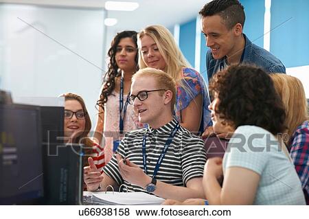 Teacher and group of students working together in computer class View Large Photo Image Stock Photo - Teacher and group of students working together in computer class. Fotosearch
