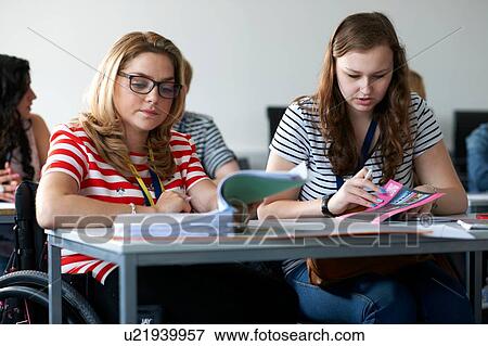 Teenage girl in wheelchair working in class View Large Photo Image Stock Photo - Teenage girl in wheelchair working in class. Fotosearch