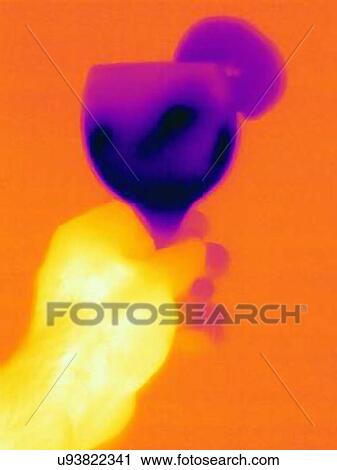 Stock Image - Thermal image hand holding cocktail in glass. Fotosearch