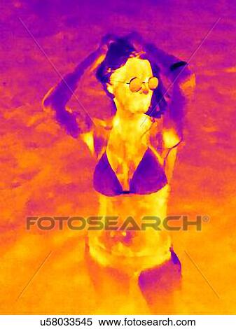 Thermal image of mid adult woman standing on beach wearing bikini hands in hair View Large Photo Image Stock Photography - Thermal image of mid adult woman standing on beach wearing bikini hands in hair. Fotosearch