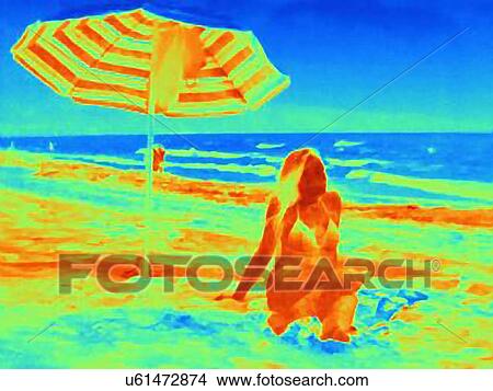 Thermal image of young woman sitting on beach underneath umbrella View Large Photo Image Picture - Thermal image of young woman sitting on beach underneath umbrella. Fotosearch