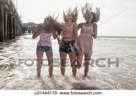 Three windswept young women having fun paddling in sea, Santa Monica, California, USA View Large Photo Image Stock Image - Three windswept young women having fun paddling in sea, Santa Monica, California, USA. Fotosearch