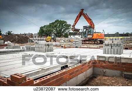Stock Photo - Tractor, building materials on construction site. Fotosearch