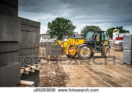 Tractor, building materials on construction site View Large Photo Image Stock Photograph - Tractor, building materials on construction site. Fotosearch