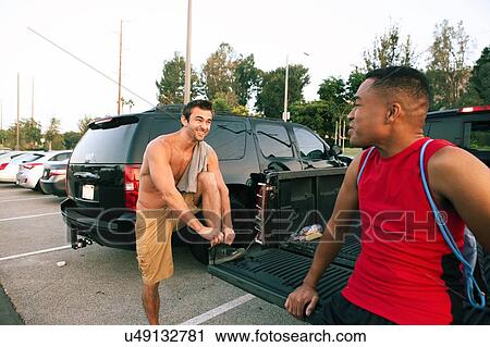 Two male friends getting ready for workout View Large Photo Image Stock Image - Two male friends getting ready for workout. Fotosearch