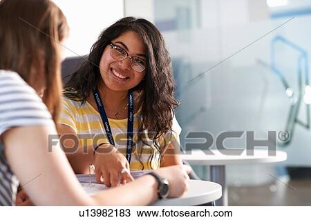 Two teenage girls working together in class View Large Photo Image Stock Image - Two teenage girls working together in class. Fotosearch
