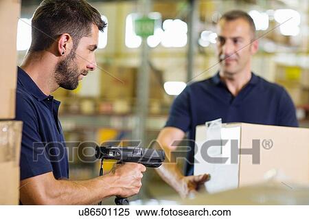 Stock Photography - Two warehouse workers using barcode scanner in distribution warehouse. Fotosearch