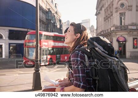 Stock Image - Two women backpackers in city with map and guidebook. Fotosearch