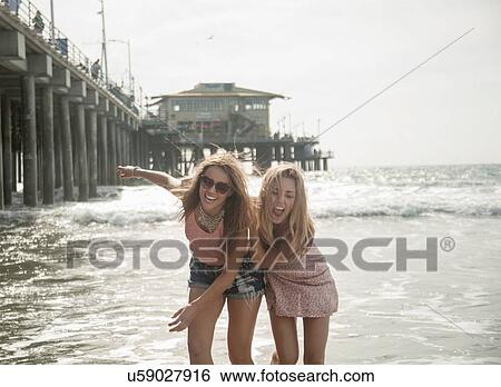 Two young women fooling around on beach, Santa Monica, California, USA View Large Photo Image Stock Photograph - Two young women fooling around on beach, Santa Monica, California, USA. Fotosearch