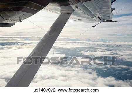 View of airplane wing above clouds View Large Photo Image Stock Image - View of airplane wing above clouds. Fotosearch