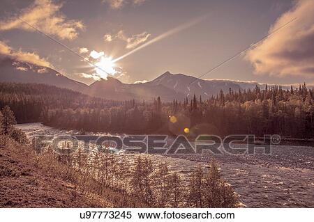 Stock Photography - View of frozen river and mountains at dawn, Ural mountains, Russia. Fotosearch