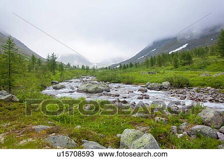 Stock Image - View of low cloud and river valley, Ural mountains, Russia. Fotosearch