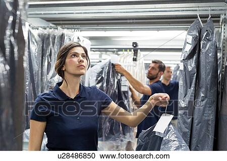Warehouse workers doing garment stock take in distribution warehouse View Large Photo Image Stock Image - Warehouse workers doing garment stock take in distribution warehouse. Fotosearch
