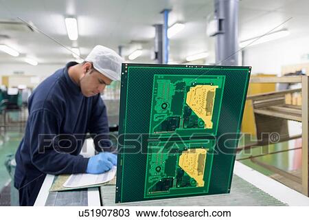 Worker creating circuit board printing machine in circuit board factory View Large Photo Image Stock Image - Worker creating circuit board printing machine in circuit board factory. Fotosearch