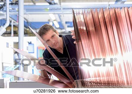Worker inspecting circuit board base layers in circuit board factory View Large Photo Image Stock Photograph - Worker inspecting circuit board base layers in circuit board factory. Fotosearch