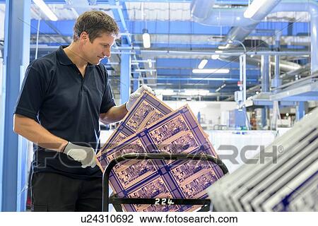 Worker inspecting circuit board in circuit board factory View Large Photo Image Stock Image - Worker inspecting circuit board in circuit board factory. Fotosearch