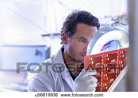 Worker inspecting circuit board in circuit board factory View Large Photo Image Stock Photograph - Worker inspecting circuit board in circuit board factory. Fotosearch