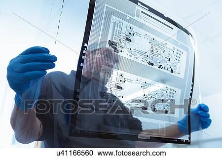 Worker inspecting circuit board negative sheet in circuit board factory View Large Photo Image Stock Image - Worker inspecting circuit board negative sheet in circuit board factory. Fotosearch