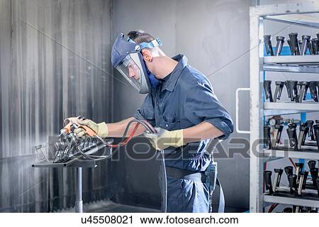 Worker paint spraying automotive parts in spray paint factory View Large Photo Image Stock Image - Worker paint spraying automotive parts in spray paint factory. Fotosearch