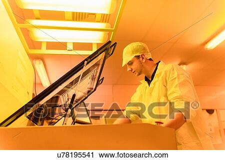 Worker printing circuit board under photographically safe light in circuit board factory View Large Photo Image Stock Image - Worker printing circuit board under photographically safe light in circuit board factory. Fotosearch