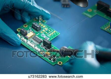 Worker soldering circuit board in electronics factory, close up View Large Photo Image Stock Image - Worker soldering circuit board in electronics factory, close up. Fotosearch