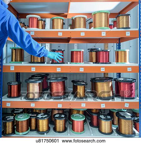 Worker taking coil of wire from shelf in electronics factory View Large Photo Image Stock Image - Worker taking coil of wire from shelf in electronics factory. Fotosearch