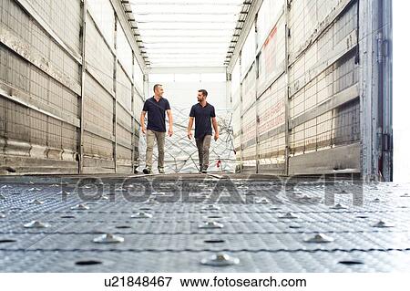Workers and freight in air freight container View Large Photo Image Stock Photo - Workers and freight in air freight container. Fotosearch