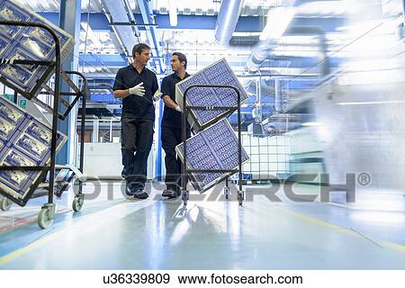 Stock Photo - Workers in circuit board manufacturing factory. Fotosearch