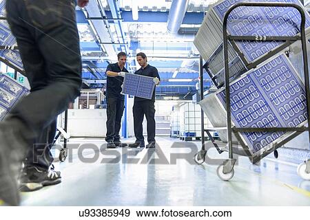 Stock Photo - Workers in circuit board manufacturing factory. Fotosearch