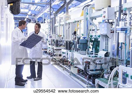 Workers inspecting circuit board by processing plant in circuit board factory View Large Photo Image Stock Image - Workers inspecting circuit board by processing plant in circuit board factory. Fotosearch