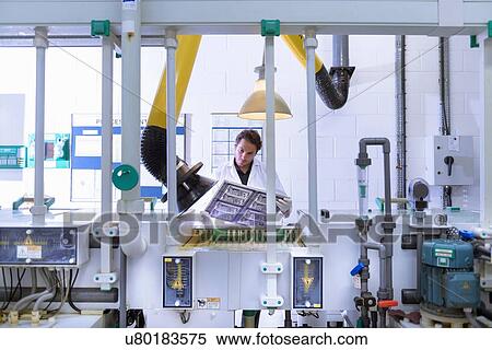 Workers inspecting circuit board by processing plant in circuit board factory View Large Photo Image Stock Photography - Workers inspecting circuit board by processing plant in circuit board factory. Fotosearch