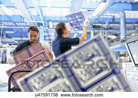 Stock Photo - Workers inspecting circuit board in circuit board factory. Fotosearch