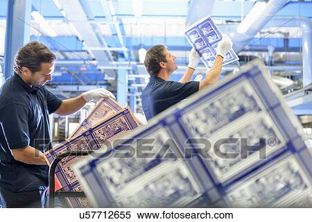 Stock Photography - Workers inspecting circuit board in circuit board factory. Fotosearch