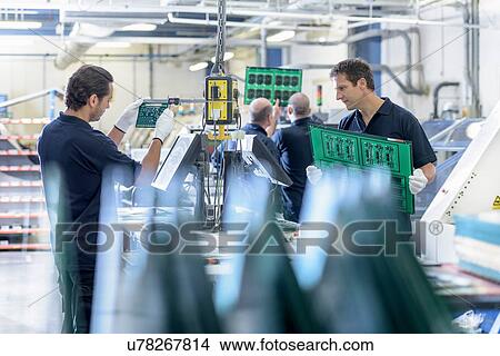 Picture - Workers inspecting circuit boards in circuit board factory. Fotosearch