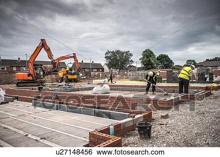 Workers laying bricks on construction site View Large Photo Image Stock Photograph - Workers laying bricks on construction site. Fotosearch