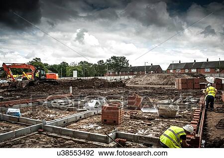 Stock Image - Workers on construction site. Fotosearch