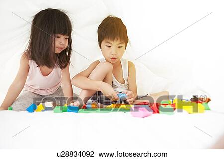 Young Chinese boy and girl in bed playing with their toys under the bedsheets View Large Photo Image Stock Image - Young Chinese boy and girl in bed playing with their toys under the bedsheets. Fotosearch