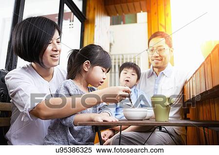 Young Chinese family having breakfast on the balcony in the sunshine together View Large Photo Image Stock Photography - Young Chinese family having breakfast on the balcony in the sunshine together. Fotosearch