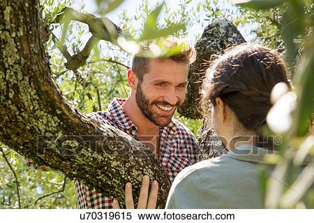 Young couple in tree face to face smiling View Large Photo Image Stock Photography - Young couple in tree face to face smiling. Fotosearch