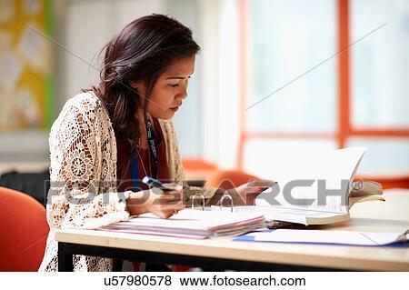 Young female student writing in file View Large Photo Image Stock Photo - Young female student writing in file. Fotosearch