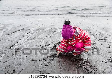 Picture - Young girl on beach, Landeyjahofn, Iceland. Fotosearch