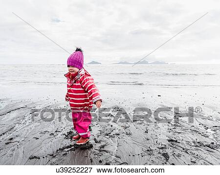 Stock Photo - Young girl on beach, Landeyjahofn, Iceland. Fotosearch